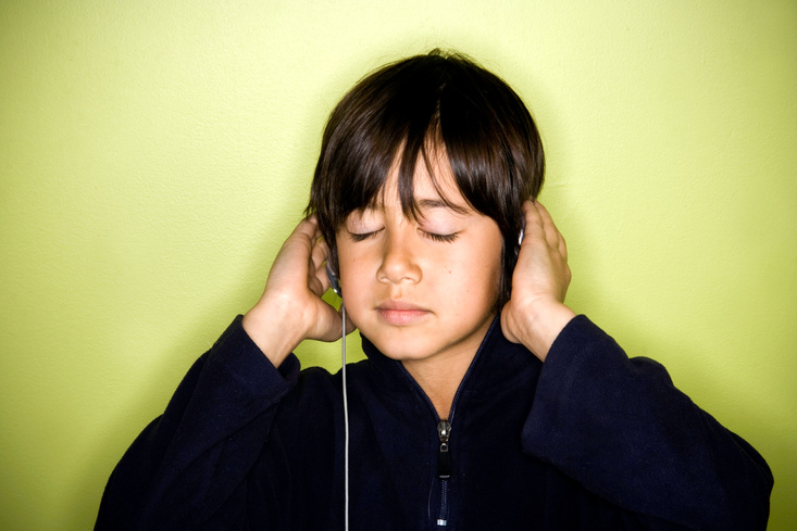 Pre-teen listens to music